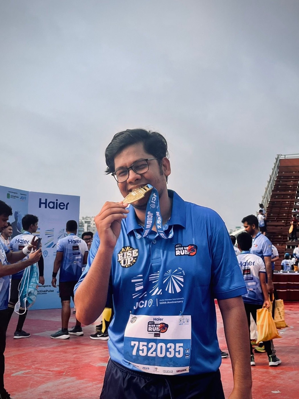 Wearing a race medal at an outdoor event