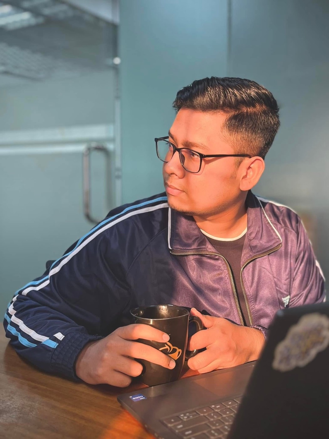 Portrait at a table with a cup