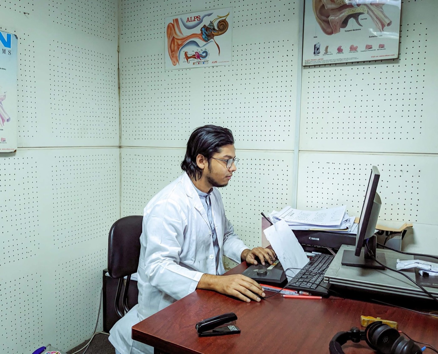 Clinical work at a computer in a lab coat